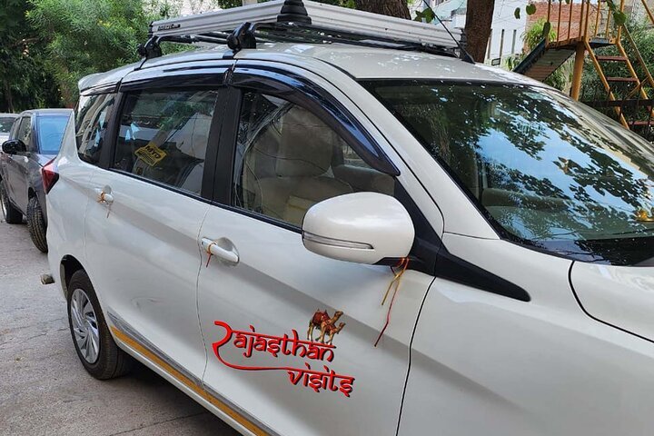 Rajasthan Visits white Ertiga taxi with driver for your Rajasthan journey
